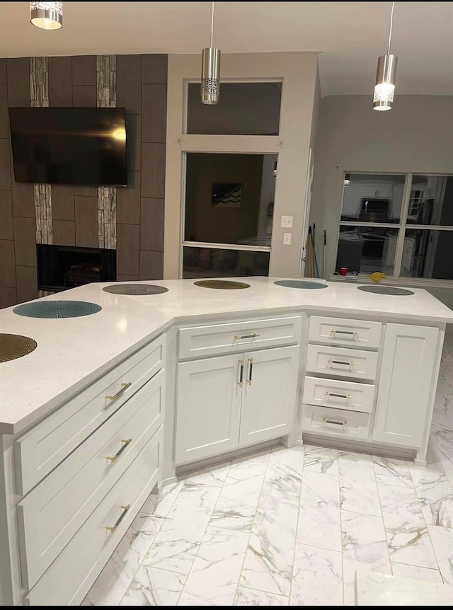 kitchen with marble finish floor, open floor plan, and light countertops