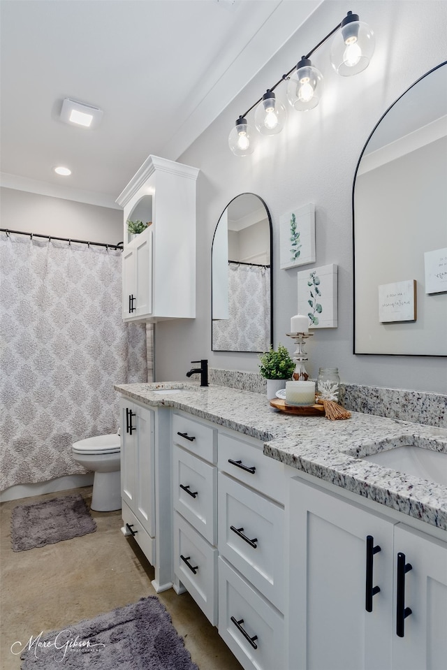 bathroom with double vanity, a shower with shower curtain, a sink, and toilet