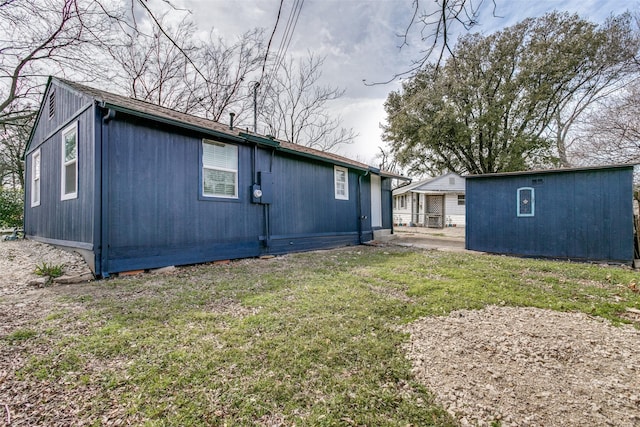 view of property exterior with a yard and an outdoor structure