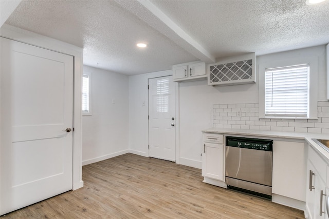 kitchen featuring light wood finished floors, white cabinets, and stainless steel dishwasher