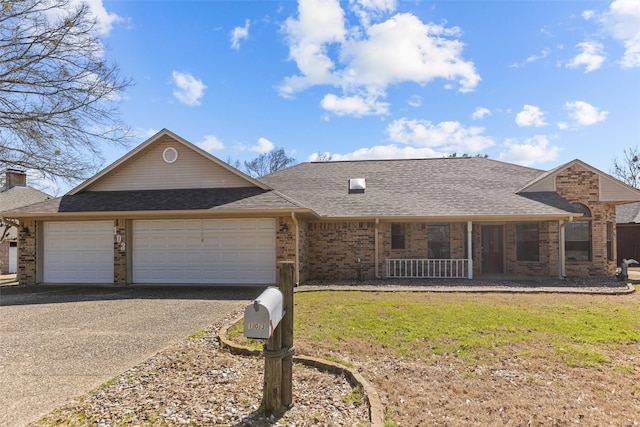 single story home with brick siding, roof with shingles, an attached garage, a front yard, and driveway