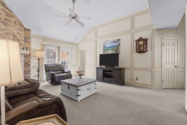 carpeted living room with lofted ceiling, a textured ceiling, a ceiling fan, and a decorative wall