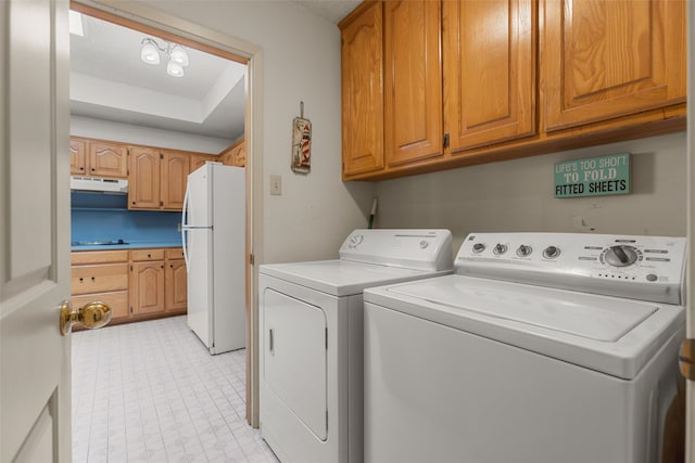 washroom with washer and dryer and light floors