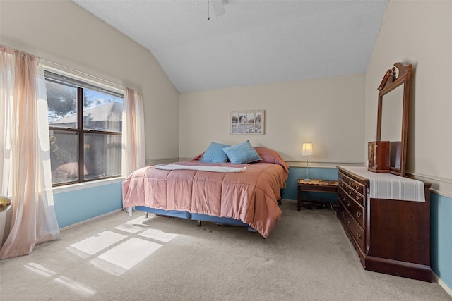 bedroom with carpet floors, lofted ceiling, ceiling fan, and baseboards