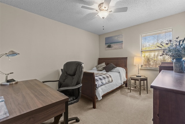 bedroom featuring carpet, ceiling fan, and a textured ceiling