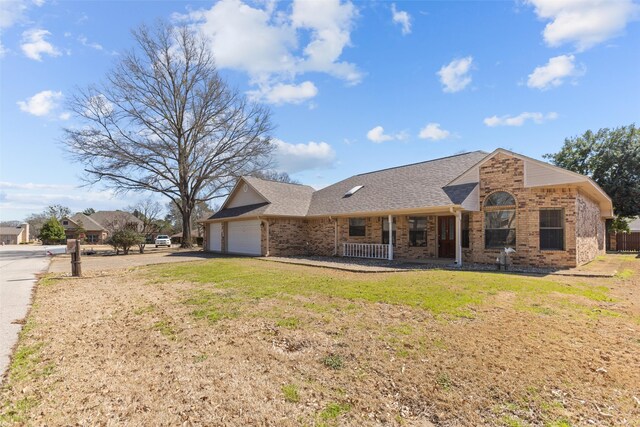 103 Holly Hill Ln, Bullard, TX 75757 - back of property featuring driveway, a shingled roof, an attached garage, a porch, and brick siding