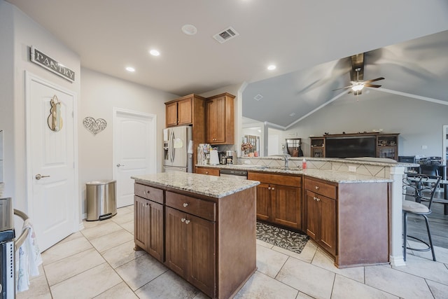 kitchen featuring visible vents, a peninsula, a sink, stainless steel appliances, and open floor plan