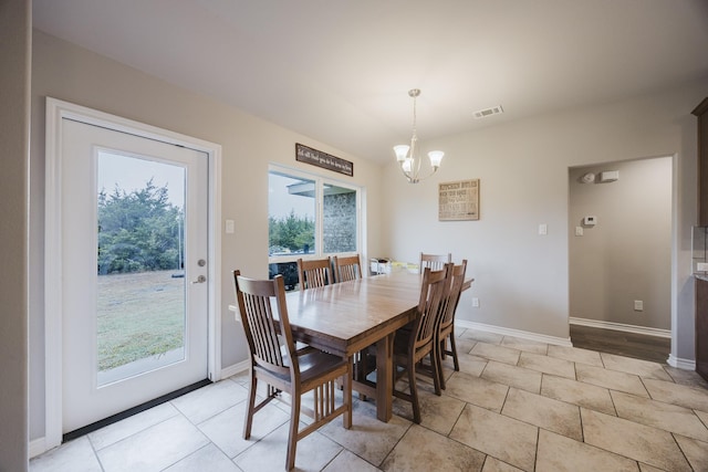 dining room with light tile patterned floors, visible vents, baseboards, and an inviting chandelier