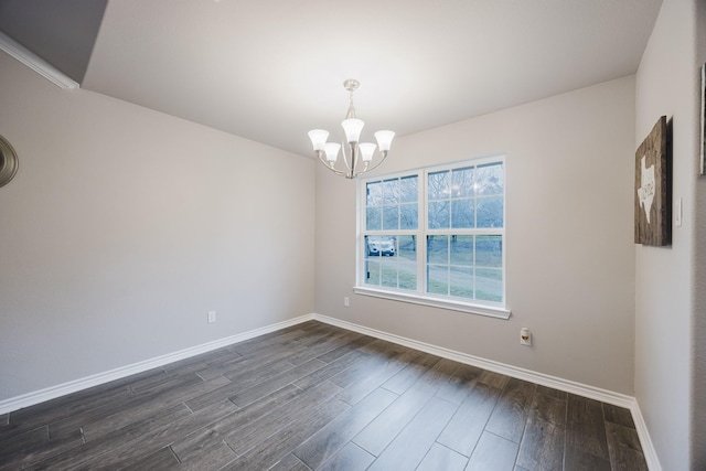 unfurnished room featuring baseboards, an inviting chandelier, and dark wood-style floors