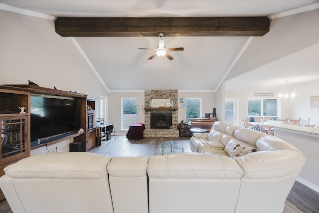 living area featuring a brick fireplace, vaulted ceiling with beams, crown molding, and wood finished floors