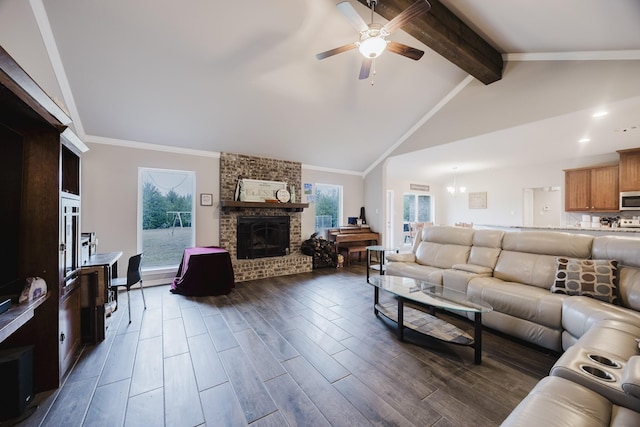 living room with vaulted ceiling with beams, ceiling fan, ornamental molding, dark wood-type flooring, and a brick fireplace