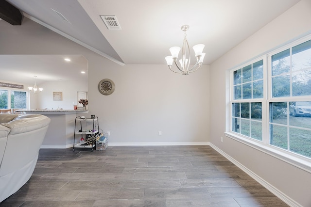 dining area with visible vents, baseboards, an inviting chandelier, and wood finished floors