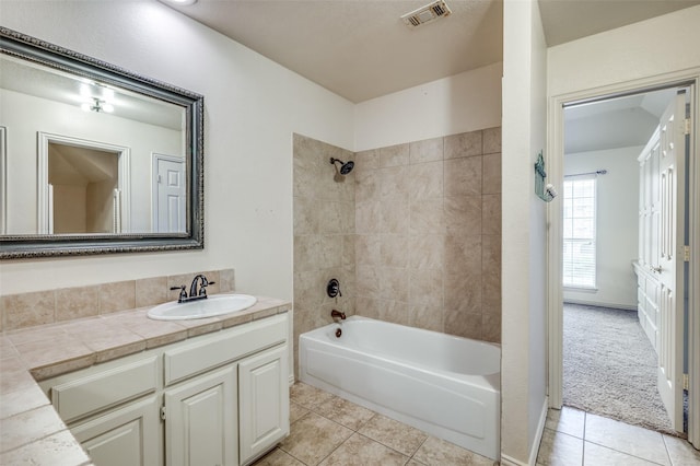 bathroom featuring shower / bath combination, vanity, visible vents, and tile patterned floors