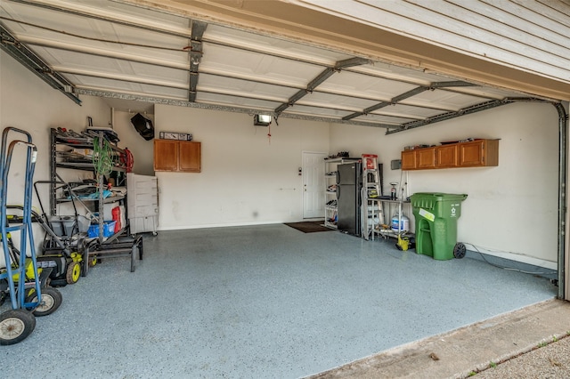 garage with a garage door opener and freestanding refrigerator