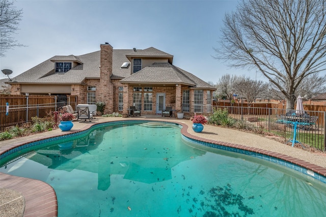 view of swimming pool featuring a fenced backyard, a fenced in pool, and a patio