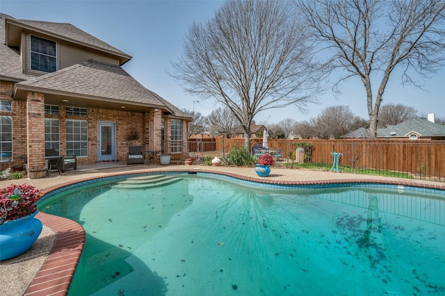 view of pool featuring fence, a fenced in pool, and a patio