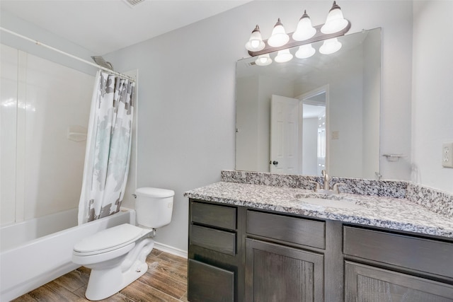 bathroom with toilet, wood finished floors, vanity, baseboards, and shower / bath combination with curtain