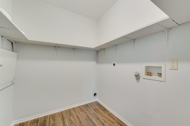 laundry room with laundry area, baseboards, wood finished floors, hookup for an electric dryer, and washer hookup