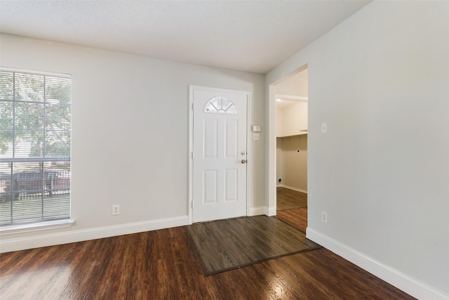 spare room featuring wood finished floors and baseboards