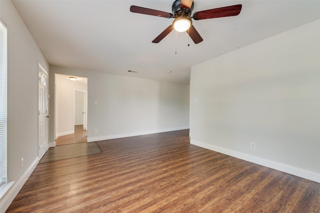 empty room featuring baseboards, visible vents, ceiling fan, and wood finished floors