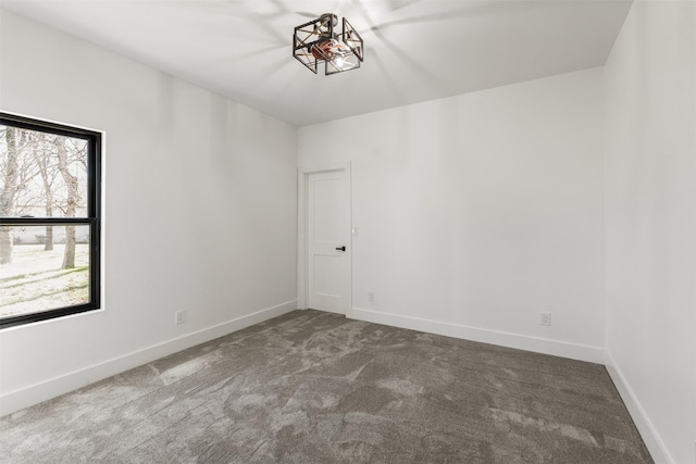 carpeted spare room with baseboards