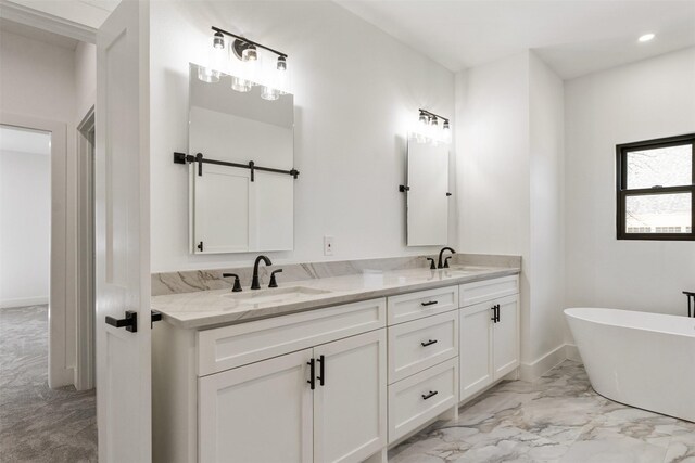 full bath with a sink, a soaking tub, marble finish floor, and double vanity