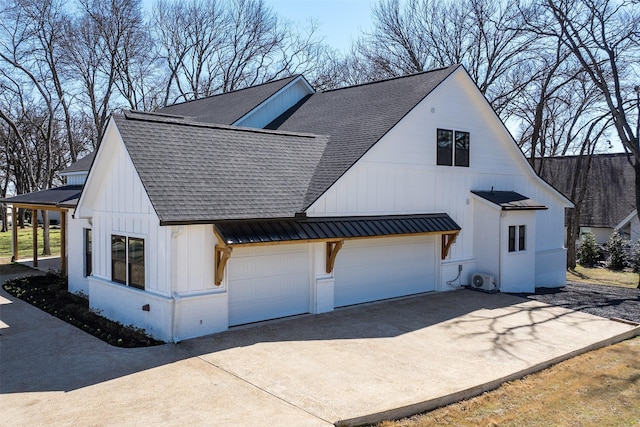 view of home's exterior with board and batten siding, concrete driveway, an attached garage, and a shingled roof