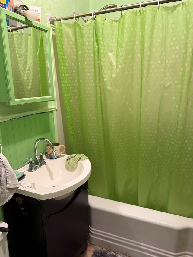 bathroom with shower / bath combo with shower curtain and vanity