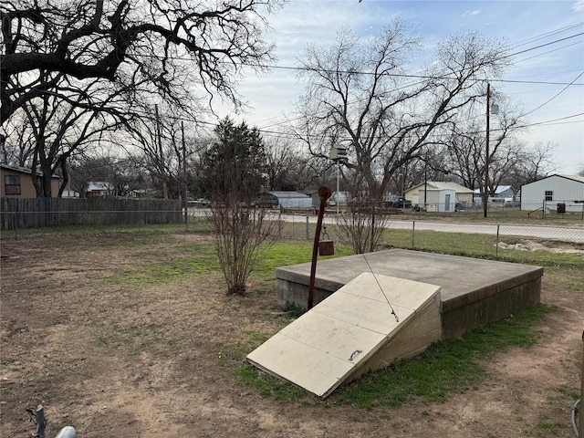 view of storm shelter featuring fence