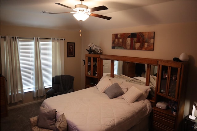 carpeted bedroom featuring visible vents, ceiling fan, and baseboards