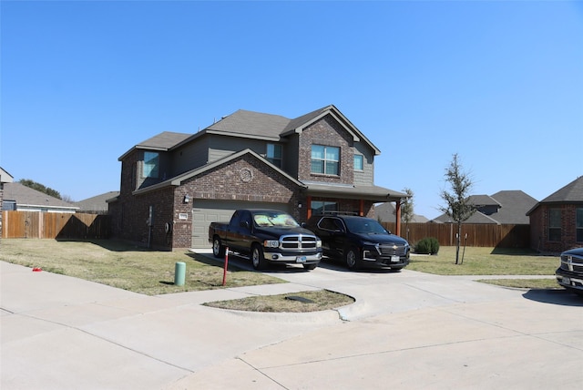 view of front facade with concrete driveway, brick siding, fence, and a front lawn