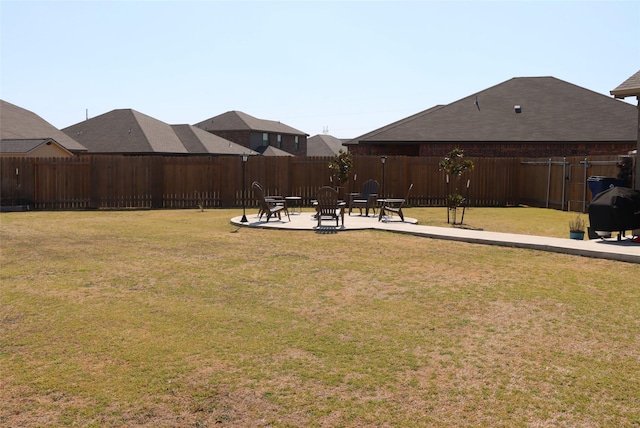 view of yard featuring a patio area and a fenced backyard