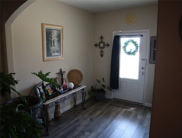 foyer entrance featuring wood finished floors and baseboards