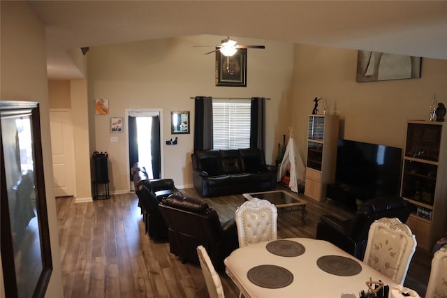 living area featuring ceiling fan, baseboards, and wood finished floors