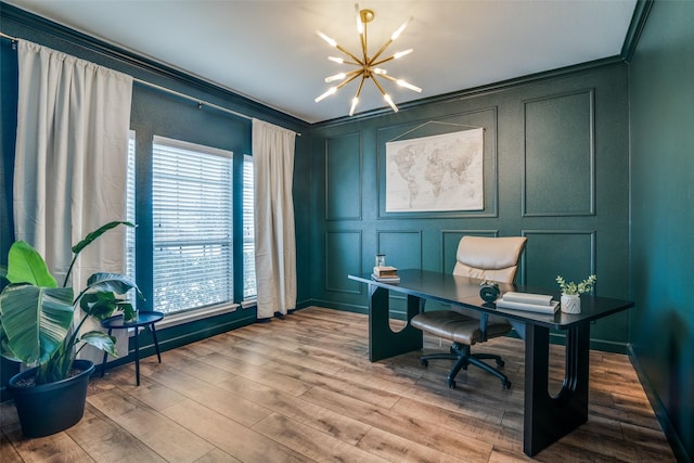 office with ornamental molding, a notable chandelier, a decorative wall, and wood finished floors