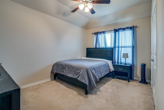 bedroom with vaulted ceiling, carpet floors, ceiling fan, and baseboards