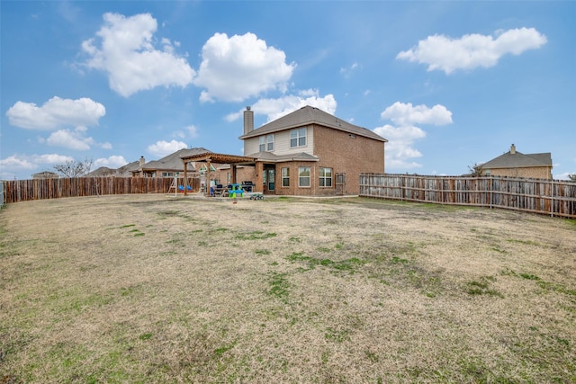 back of house featuring a lawn, a patio, a fenced backyard, a chimney, and a gazebo