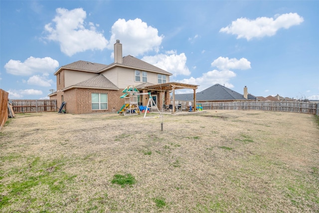 back of property featuring brick siding, a yard, a playground, a pergola, and a fenced backyard