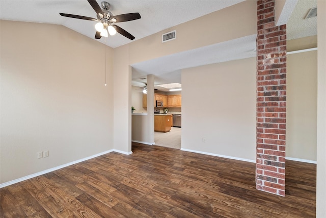 unfurnished room featuring baseboards, visible vents, ceiling fan, and wood finished floors