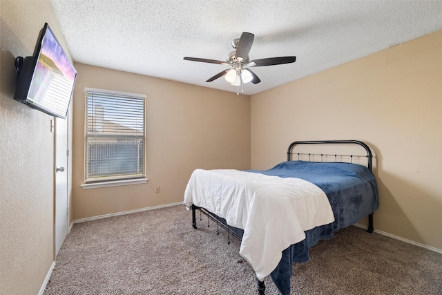 carpeted bedroom featuring ceiling fan, a textured ceiling, and baseboards