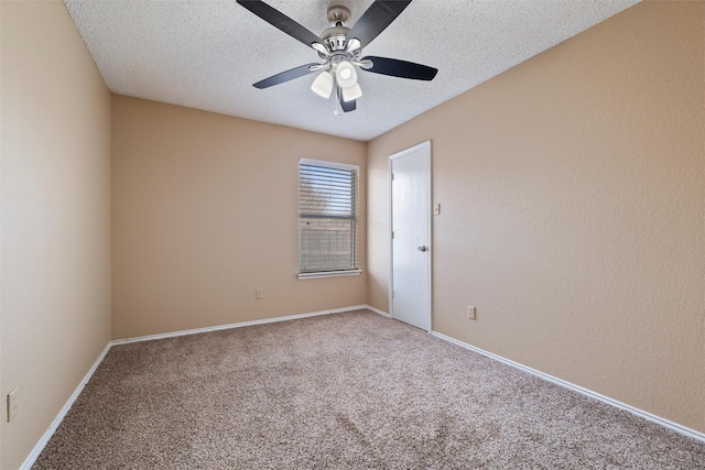 carpeted spare room with a textured wall, ceiling fan, a textured ceiling, and baseboards