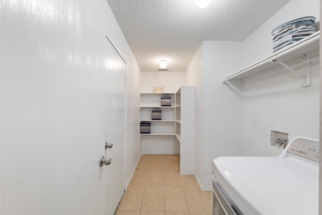 laundry room with light tile patterned floors, visible vents, a textured ceiling, washer / dryer, and laundry area