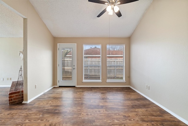 spare room featuring lofted ceiling, ceiling fan, a textured ceiling, and wood finished floors