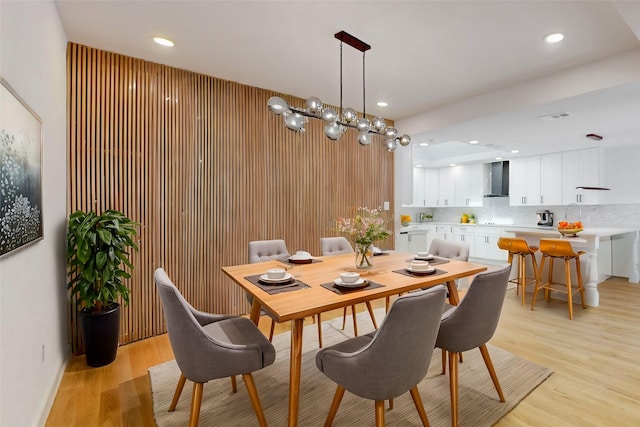 dining room with light wood-style floors, visible vents, and recessed lighting