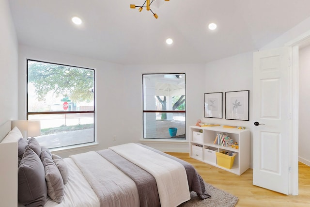 bedroom with light wood-style floors and recessed lighting