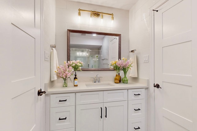 full bathroom with a shower with door and vanity