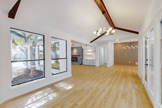 unfurnished living room with a chandelier, light wood-type flooring, a fireplace, high vaulted ceiling, and beam ceiling