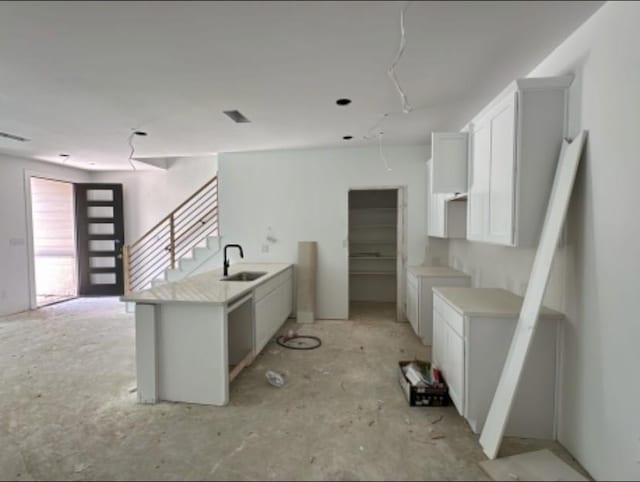 9475 Timberleaf Dr, Dallas, TX 75243 - kitchen with a peninsula, white cabinets, and light countertops