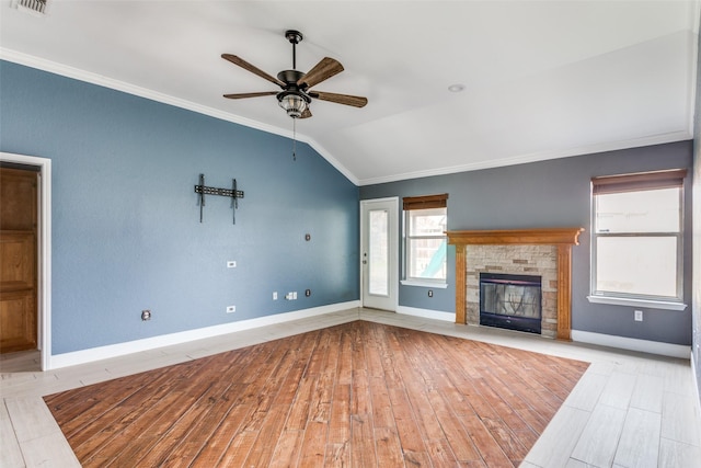 unfurnished living room with a fireplace, wood finished floors, baseboards, vaulted ceiling, and crown molding