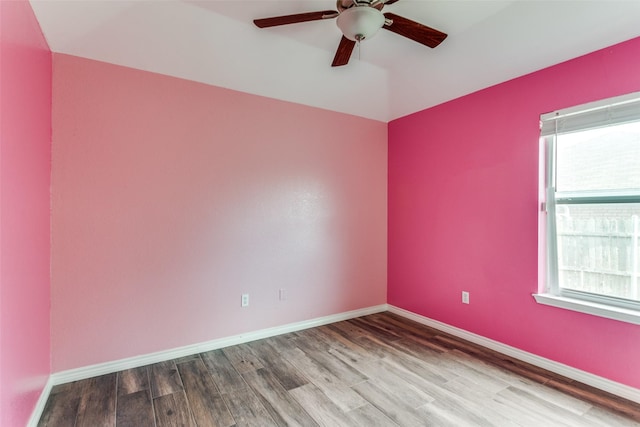 unfurnished room featuring ceiling fan, wood finished floors, and baseboards